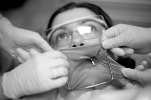 Dental patient face while dentists placing a rubberdam